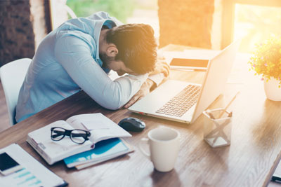 man with head down on desk